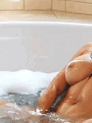 Hot busty babe masturbates in the bathtub
